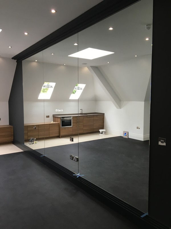 Frameless glass partition in loft conversion by Eltham glaziers