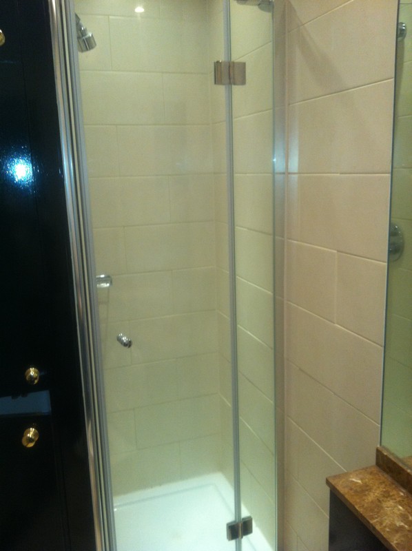 Frameless glass shower enclosure with chrome fittings in Eltham