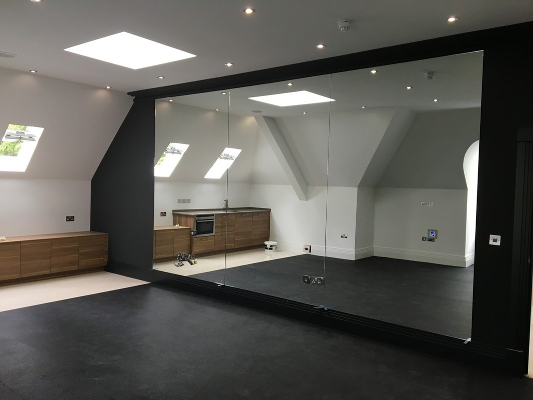 Frameless glass wall dividing loft conversion in Eltham